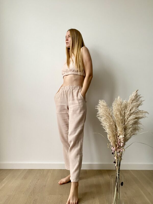 Model wearing a sleeveless organic muslin co-ord set for women with elastic crop top and wide-leg pants in lightweight cotton fabric