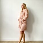 a woman in a waffle cotton robe, sustainable