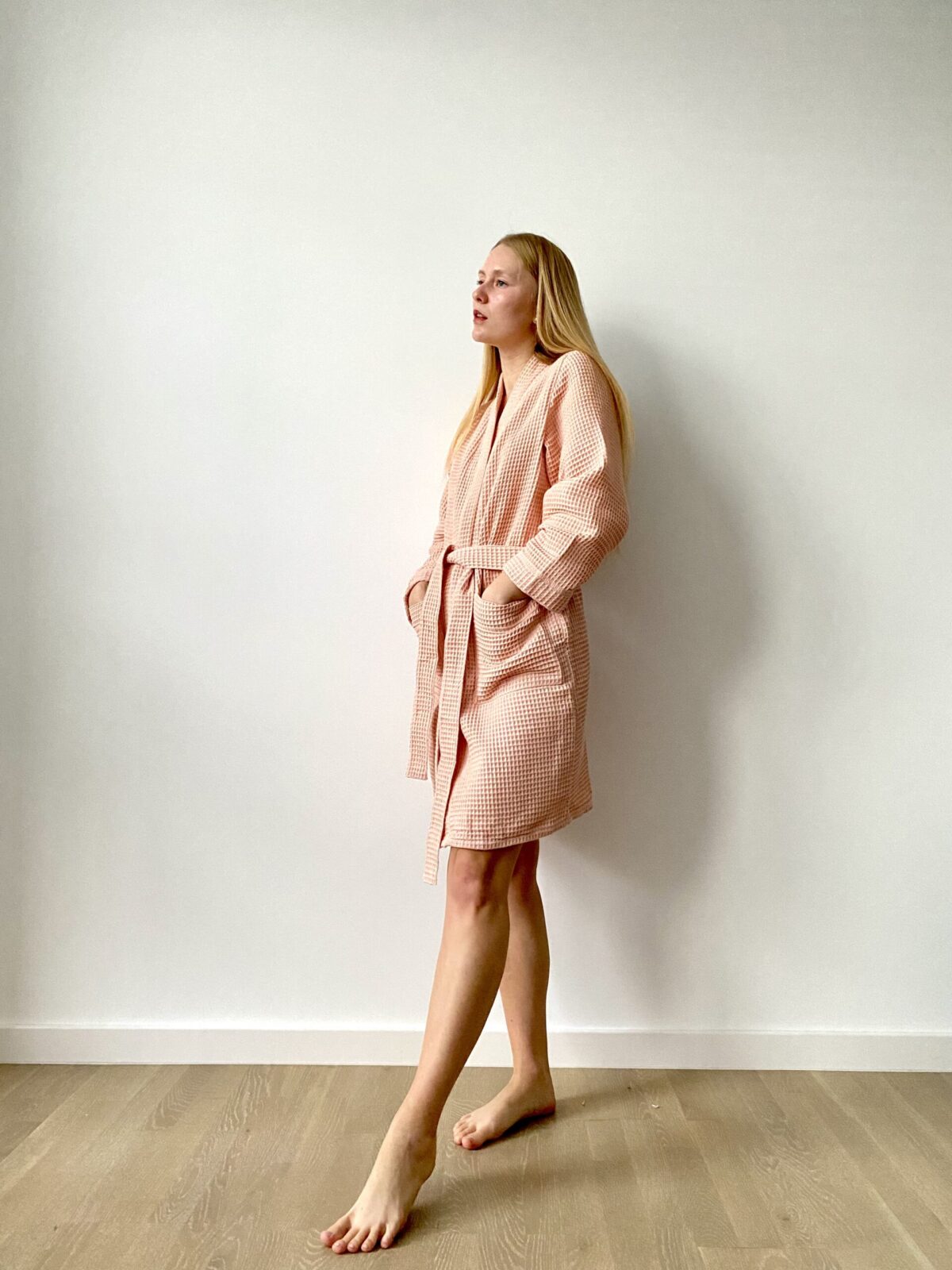 a woman in a waffle cotton robe, sustainable
