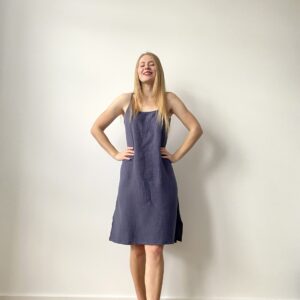Woman in sleeveless mini muslin slip dress with relaxed silhouette, front and back views.
