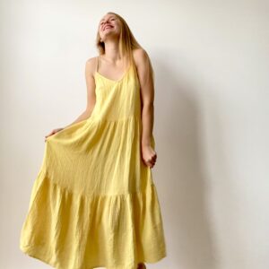 Long muslin women’s dress with flowing design and shoulder straps, ideal for warm weather and casual chic looks.