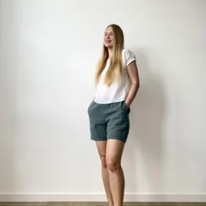 Woman wearing soft cotton muslin summer set with relaxed shorts and a short-sleeved top.
