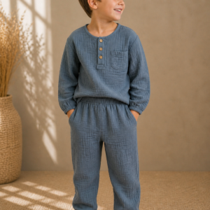 Boy wearing handmade organic cotton muslin long-sleeve top and matching trousers set
