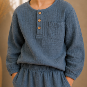 Close up boy wearing handmade organic cotton muslin long-sleeve top and matching trousers set