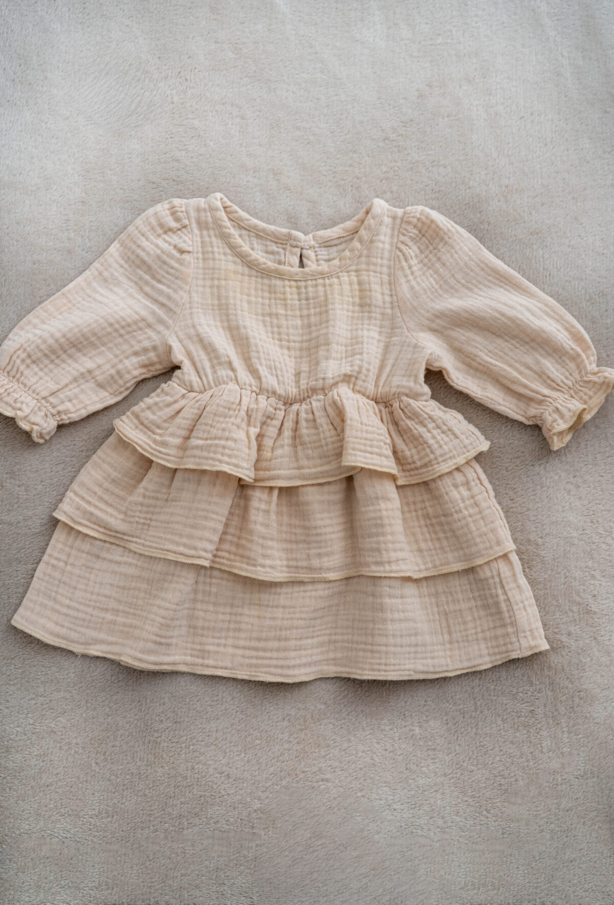 Baby girl muslin dress with long sleeves and ruffle layers