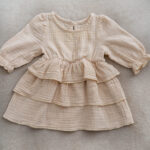 Baby girl muslin dress with long sleeves and ruffle layers