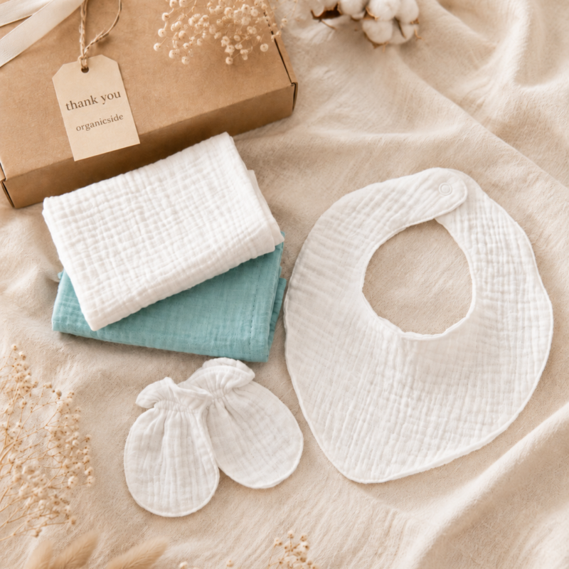 Muslin baby gift set with baby bib, mittens and coordinating soft muslin essentials